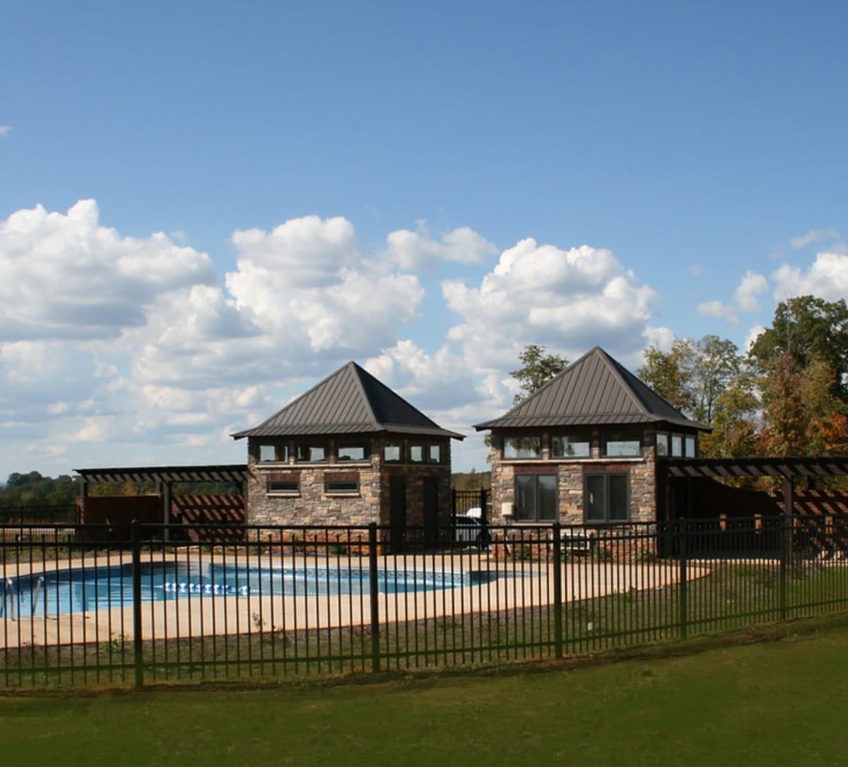 Black ornamental aluminum fence around a pool